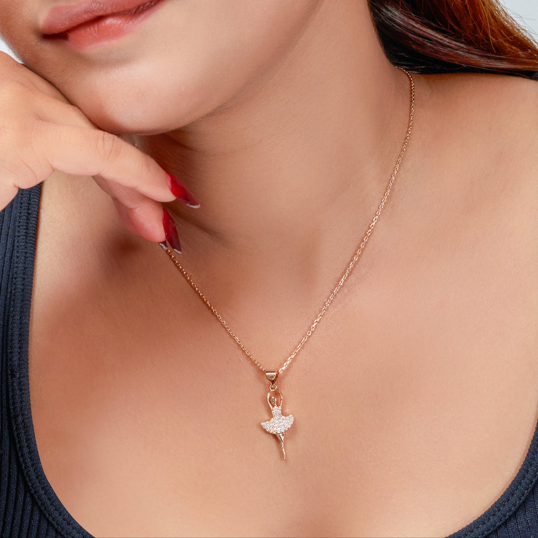 Close-up of a woman wearing a necklace with a heart pendant.