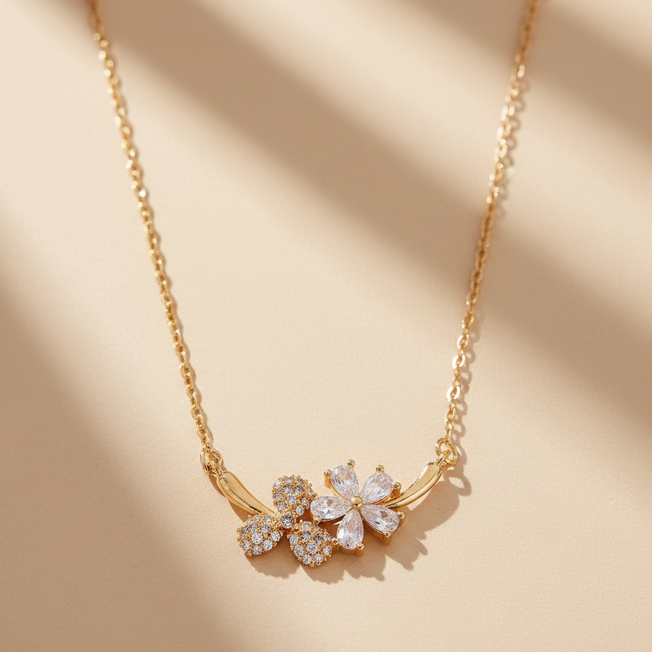 Gold necklace with floral pendant on a beige background